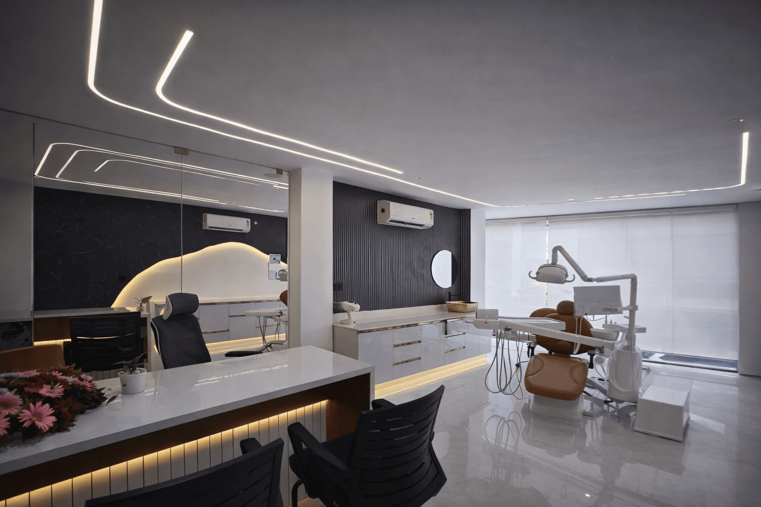 Modern two-story home with large glass windows, warmly lit interiors, and a balcony. Surrounded by trees and a manicured lawn at dusk. Cozy ambiance.