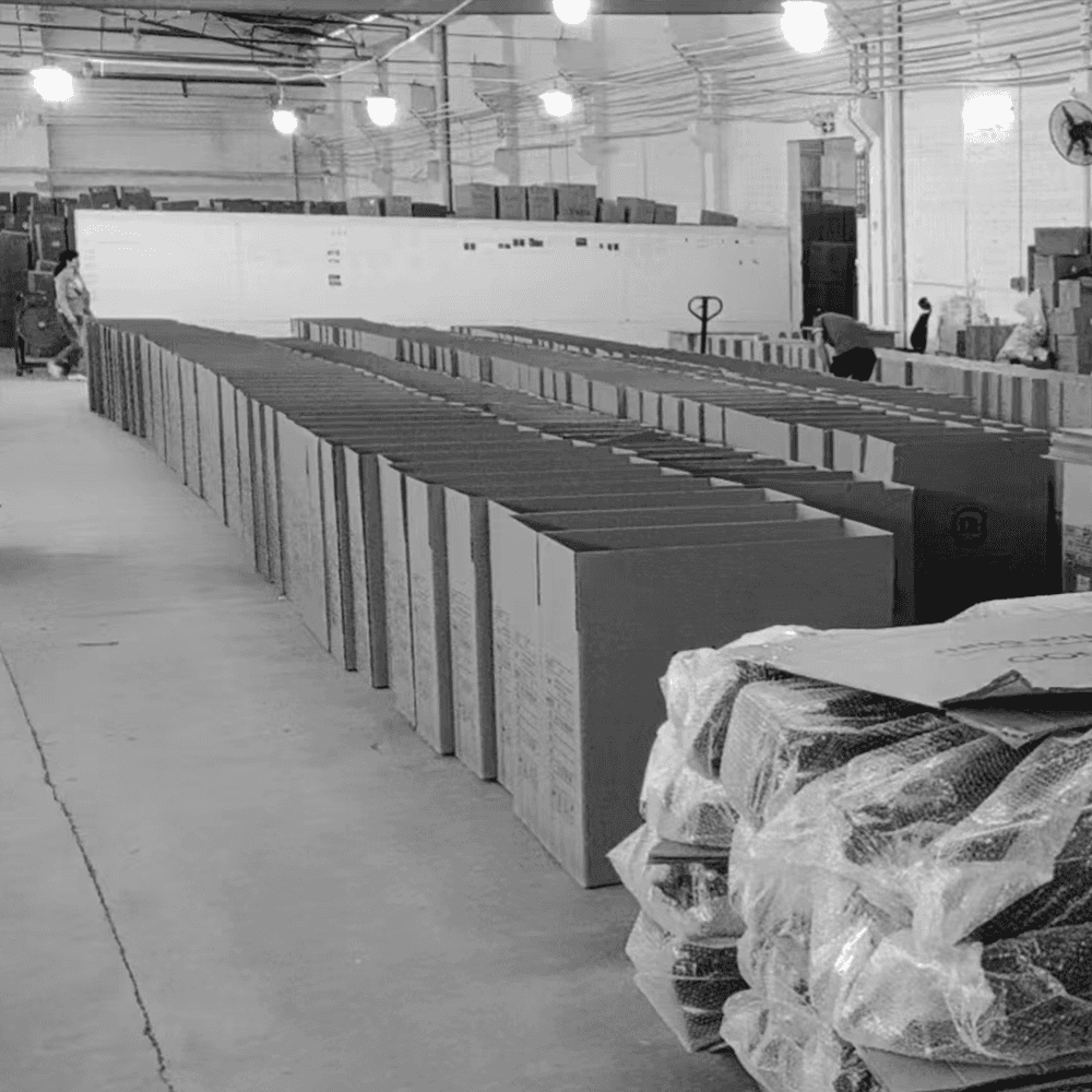 Bulk office chair orders being processed and packed in an industrial furniture factory warehouse.