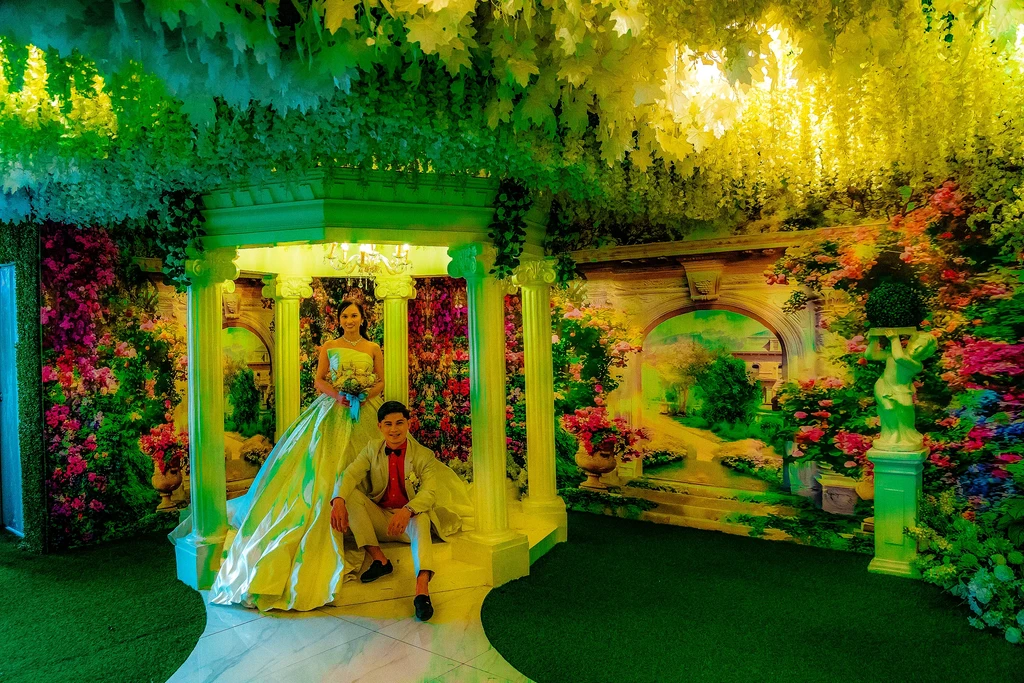 Groom at the classical garden columns of Celestia Hall, Stalla Suites QC