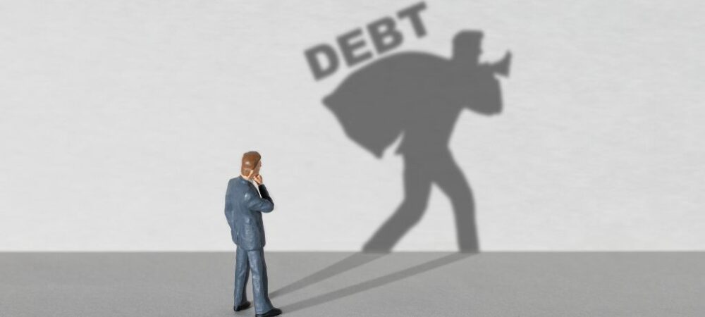 Man with shadow that says debt