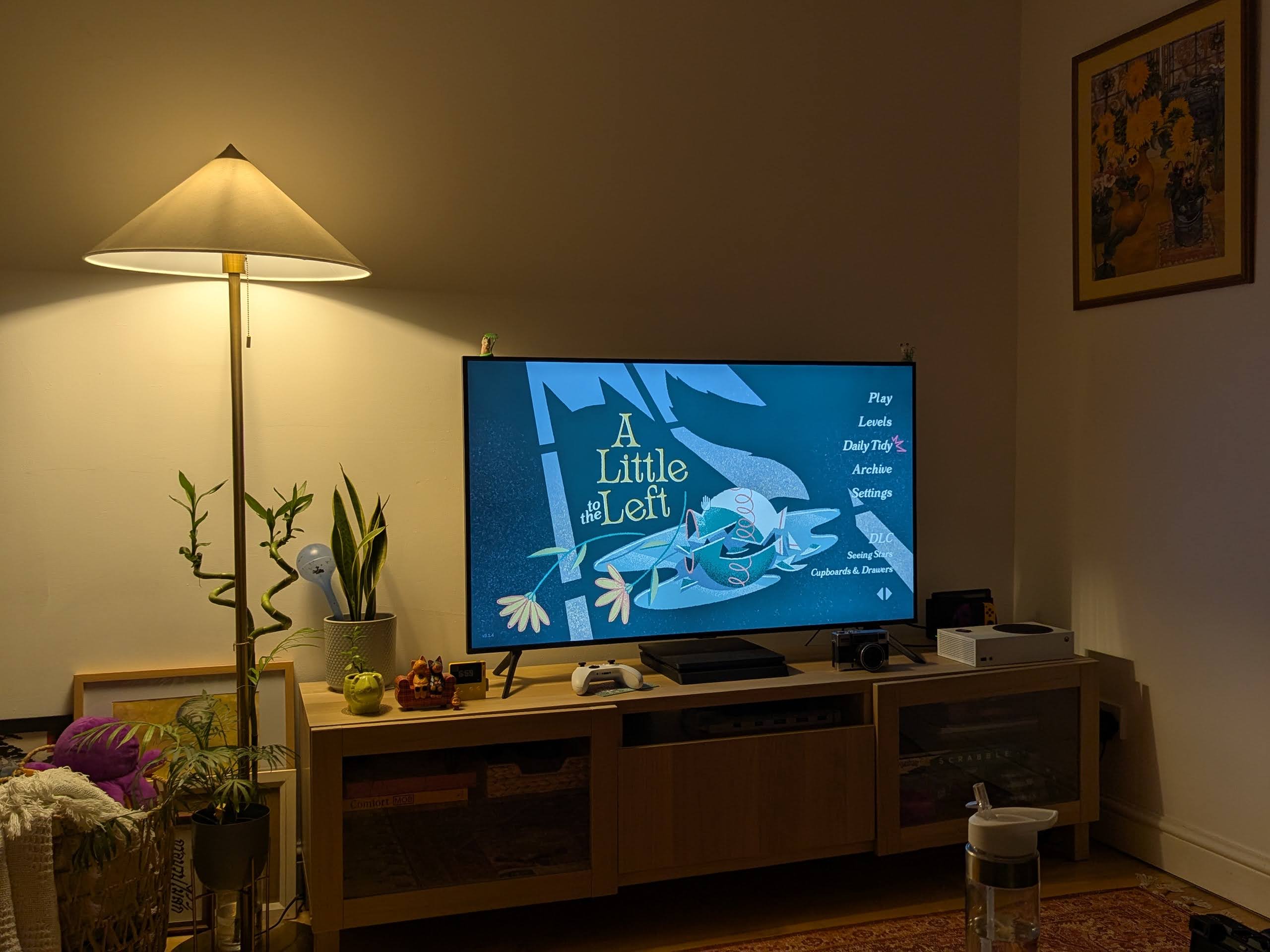 a tv showing a title screen of a game 'A little to the left'