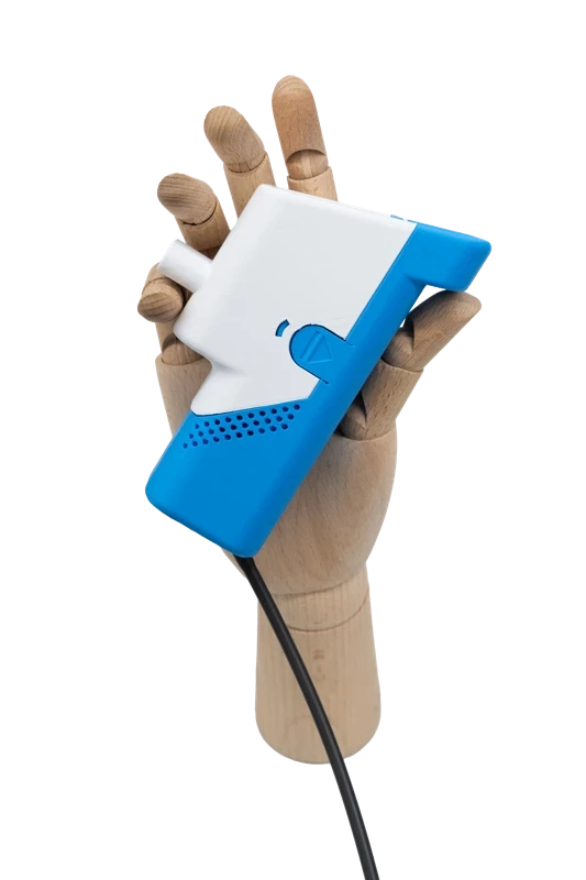 Hand holding a blue and white handheld device against a neutral background.