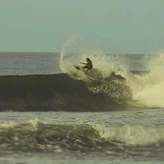 Surfer riding wave on surfboard – surfboard rental in el-zonte