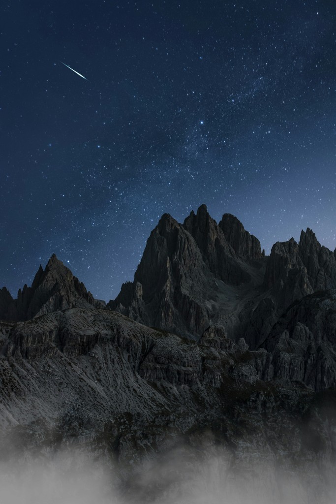 A mountain with a starry sky above