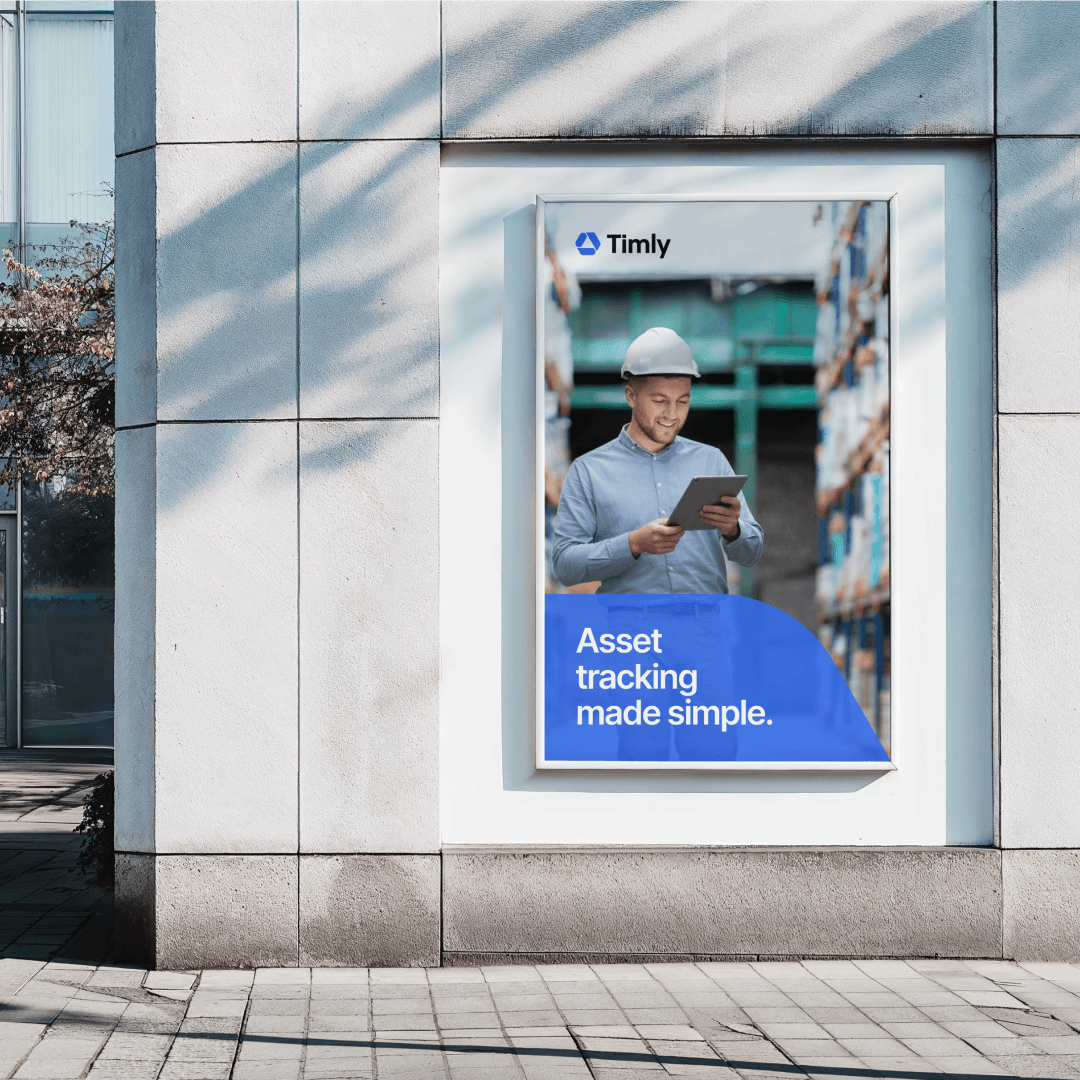 Poster design showcase for Timly’s asset tracking, featuring a blue-themed ad displayed in a modern urban environment.
