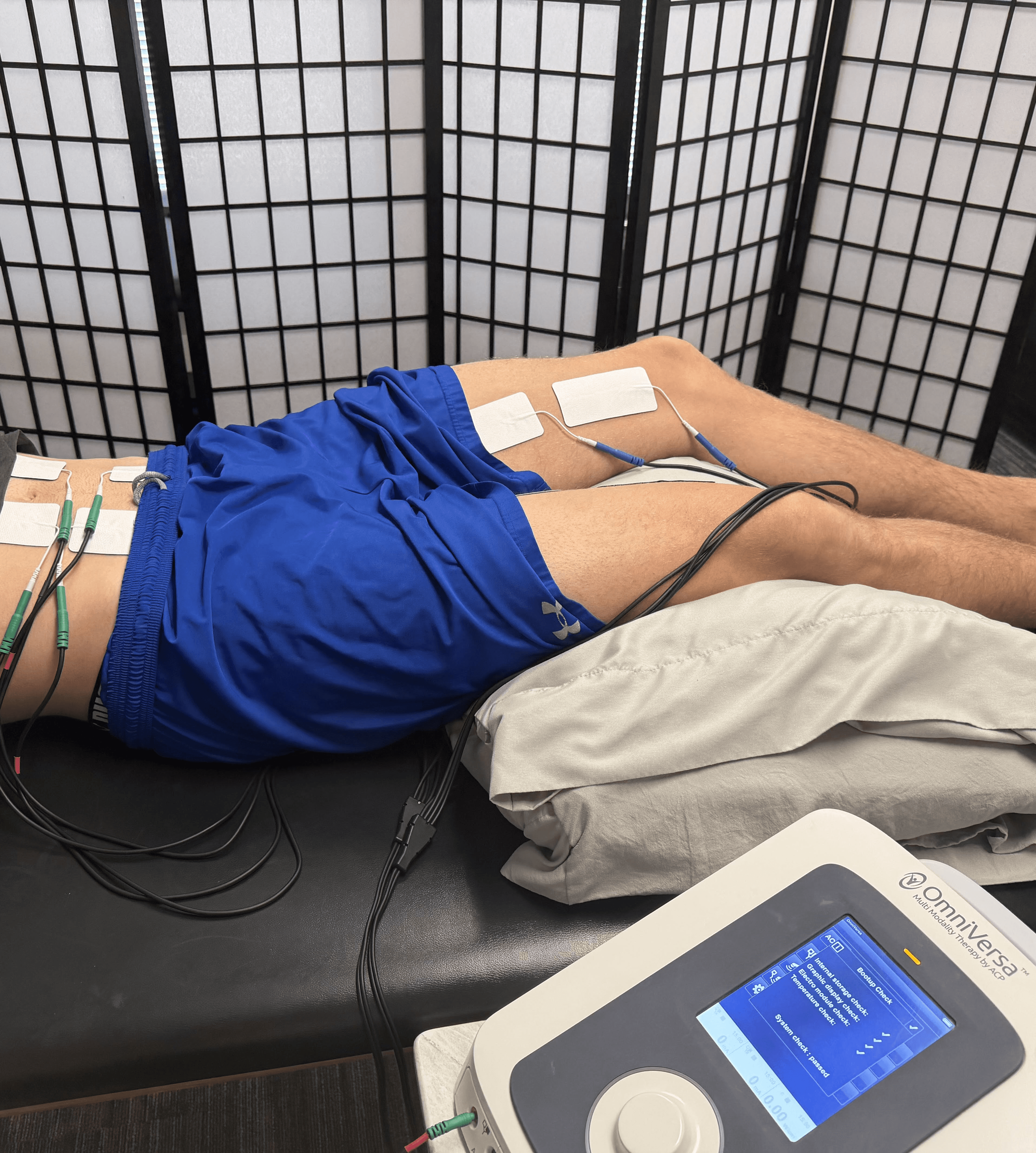 A physical therapist performing a non-invasive pelvic health assessment on a patient's abdomen to treat incontinence and improve core stability.