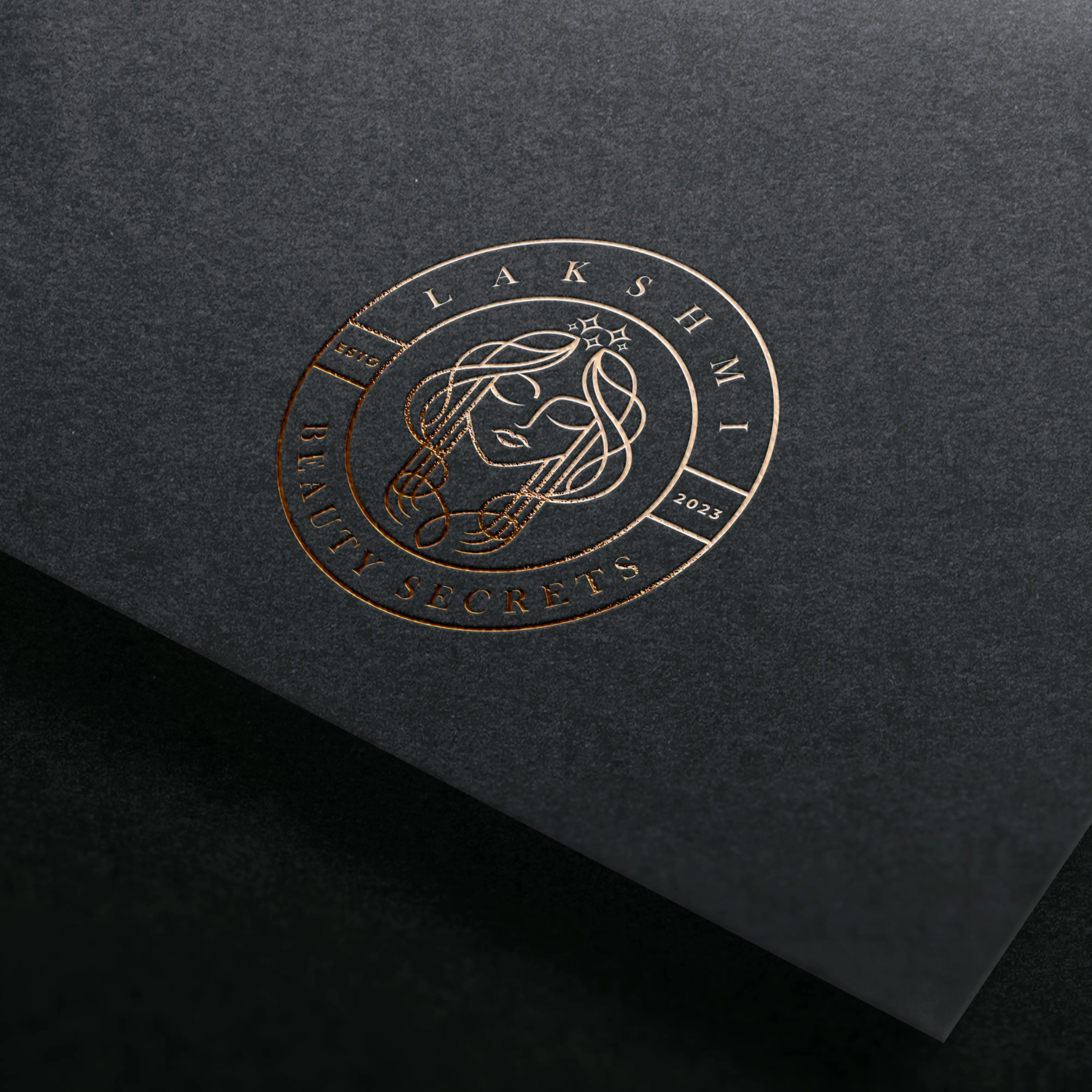 Elegant embossed brand logo on black textured paper representing luxury graphic design and branding