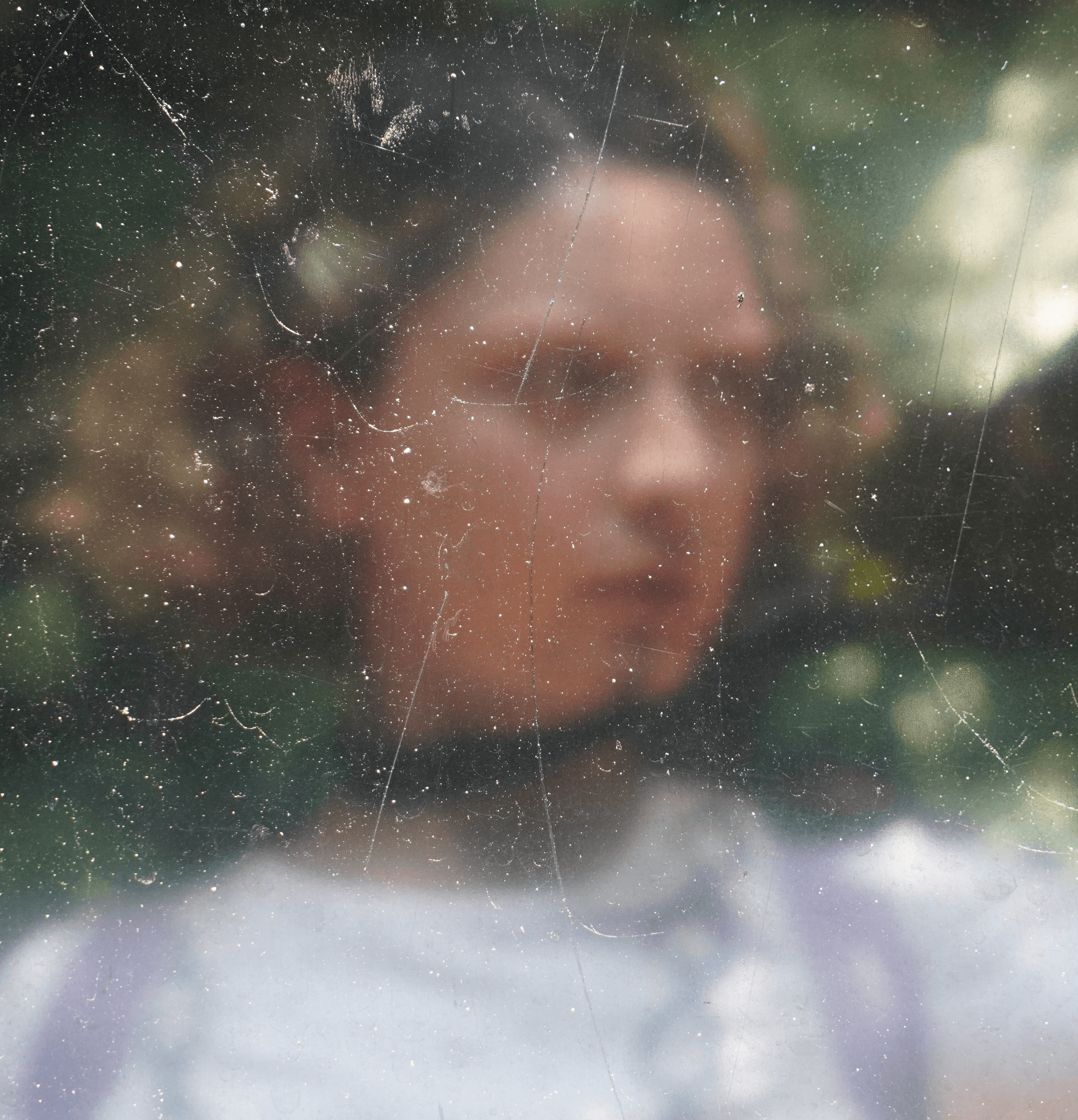 a blurry photo of a person standing in front of a wall