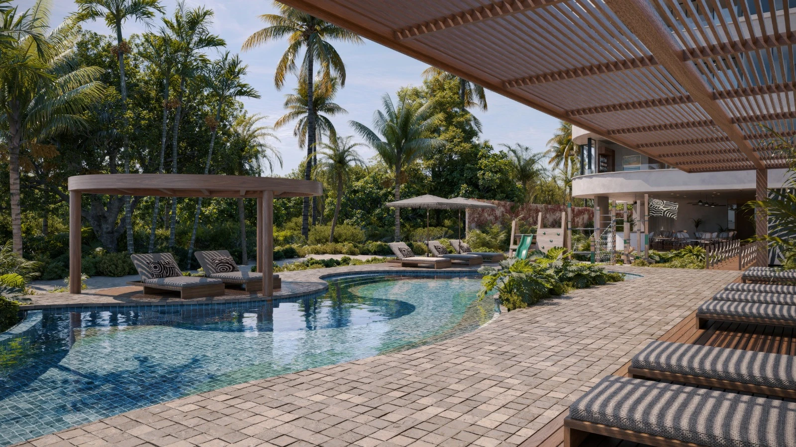 A valley with small buildings surrounded by snow-capped mountains.