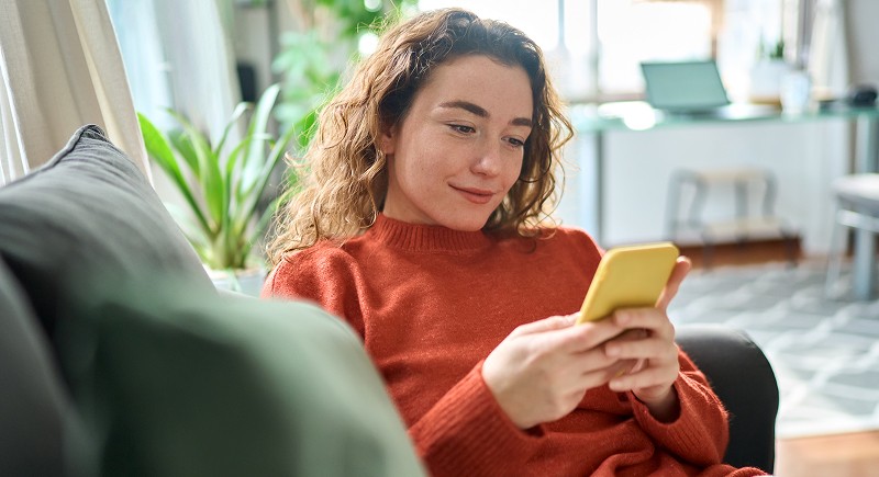 Photo of a woman looking at her smart phone