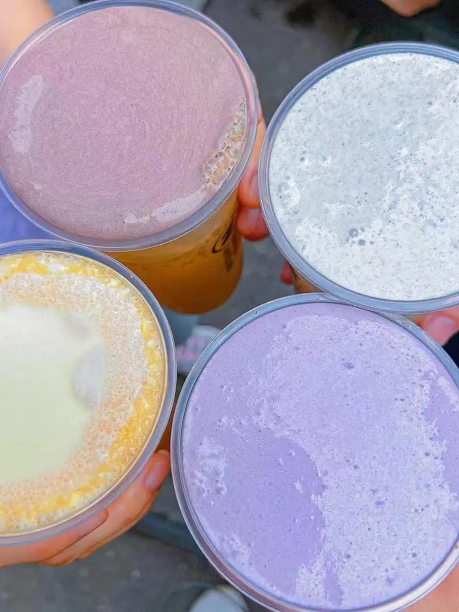  vibrant display of Cozy Tea Loft’s Cloud Series drinks, featuring colorful layers and the signature salty cheese foam topping, perfect for Instagram-worthy moments.