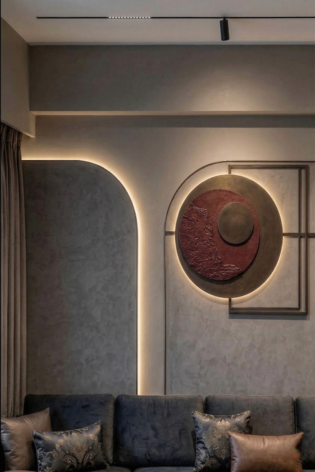 Vintage-modern living room with tufted sofas, false ceiling, and layered warm lighting.