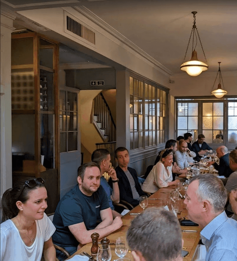 A group of people having a discussion over a meal