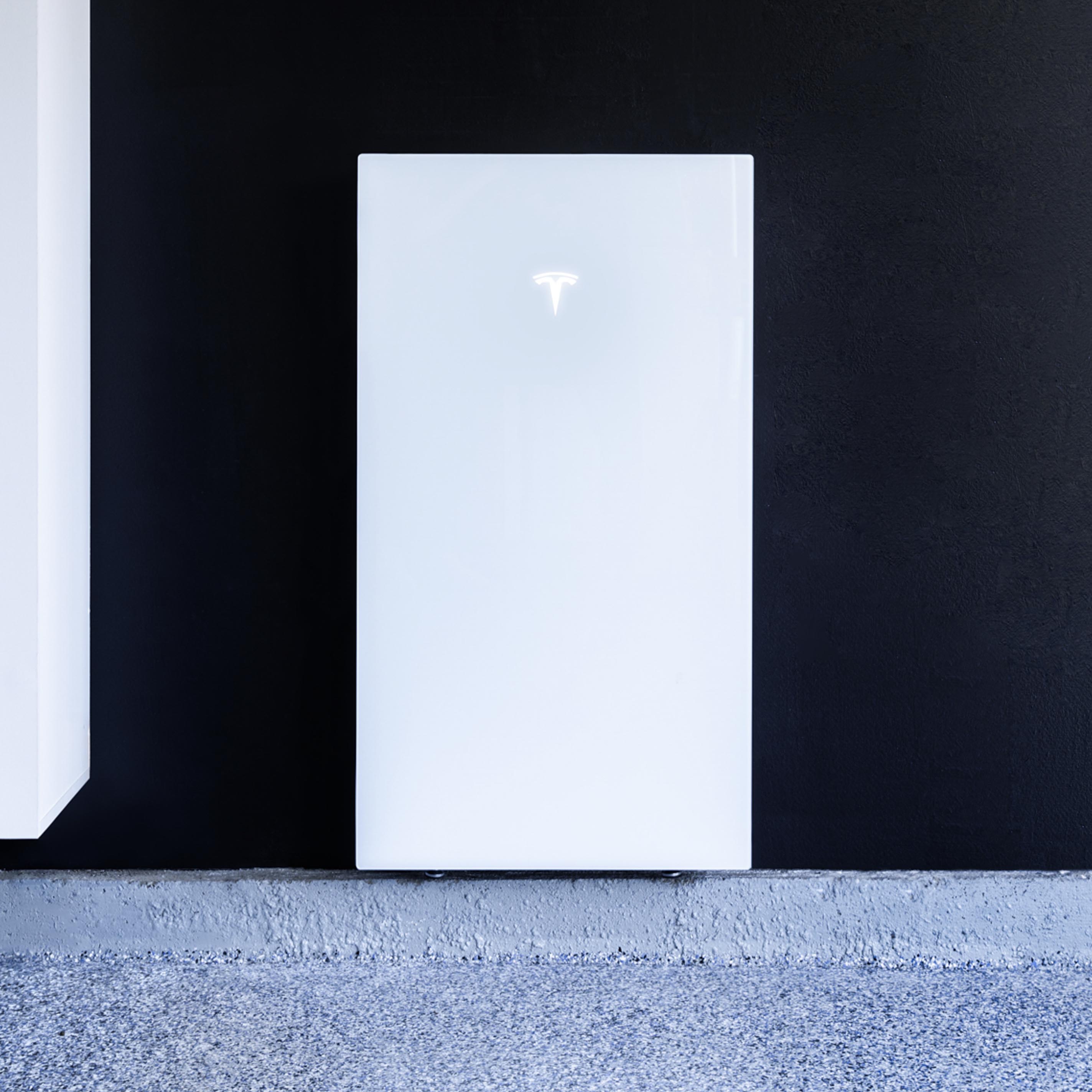 A Tesla Powerwall 3 mounted on the wall on the inside of a garage.