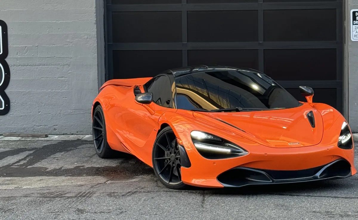 Orange McLaren 720S outside the 714 Technik roll-up door on N Tillamook St, Portland