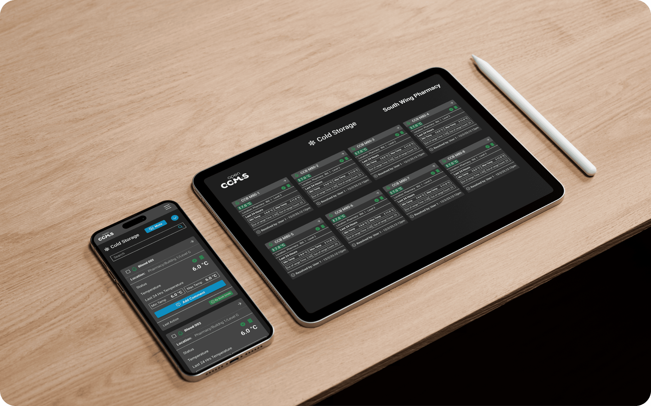 iPhone and iPad on a desk with an Apple Pencil beside them, both screens displaying the OpenCCMS cold chain system dashboard with real-time monitoring data and analytics.