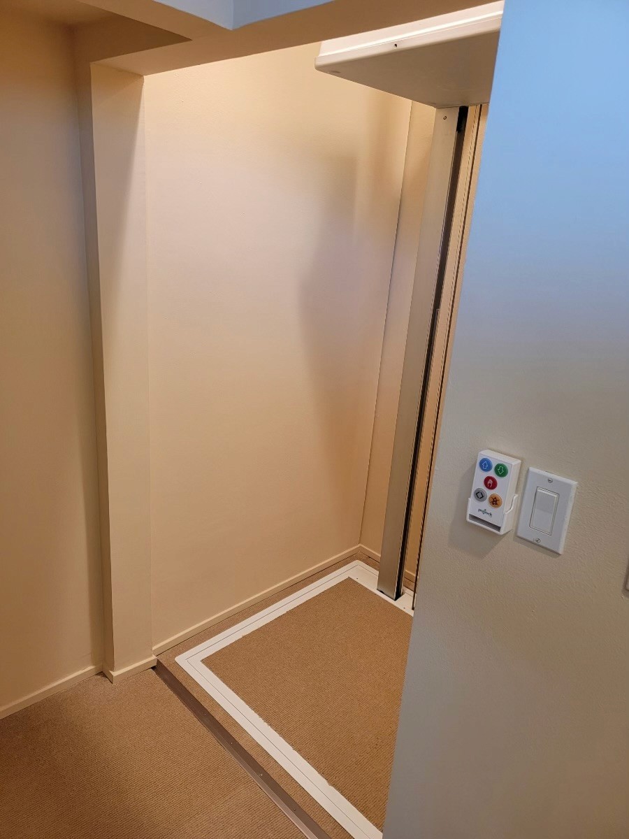 Through-the-floor home elevator installed where a spiral staircase used to be