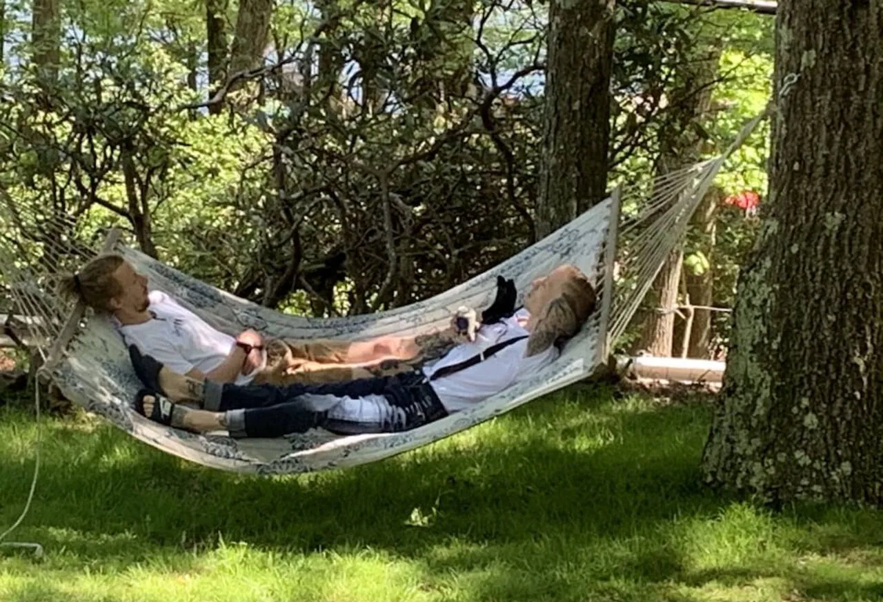 Hammock strung between trees on the shaded front lawn at Laketop Lodge, Lake Harmony, PA