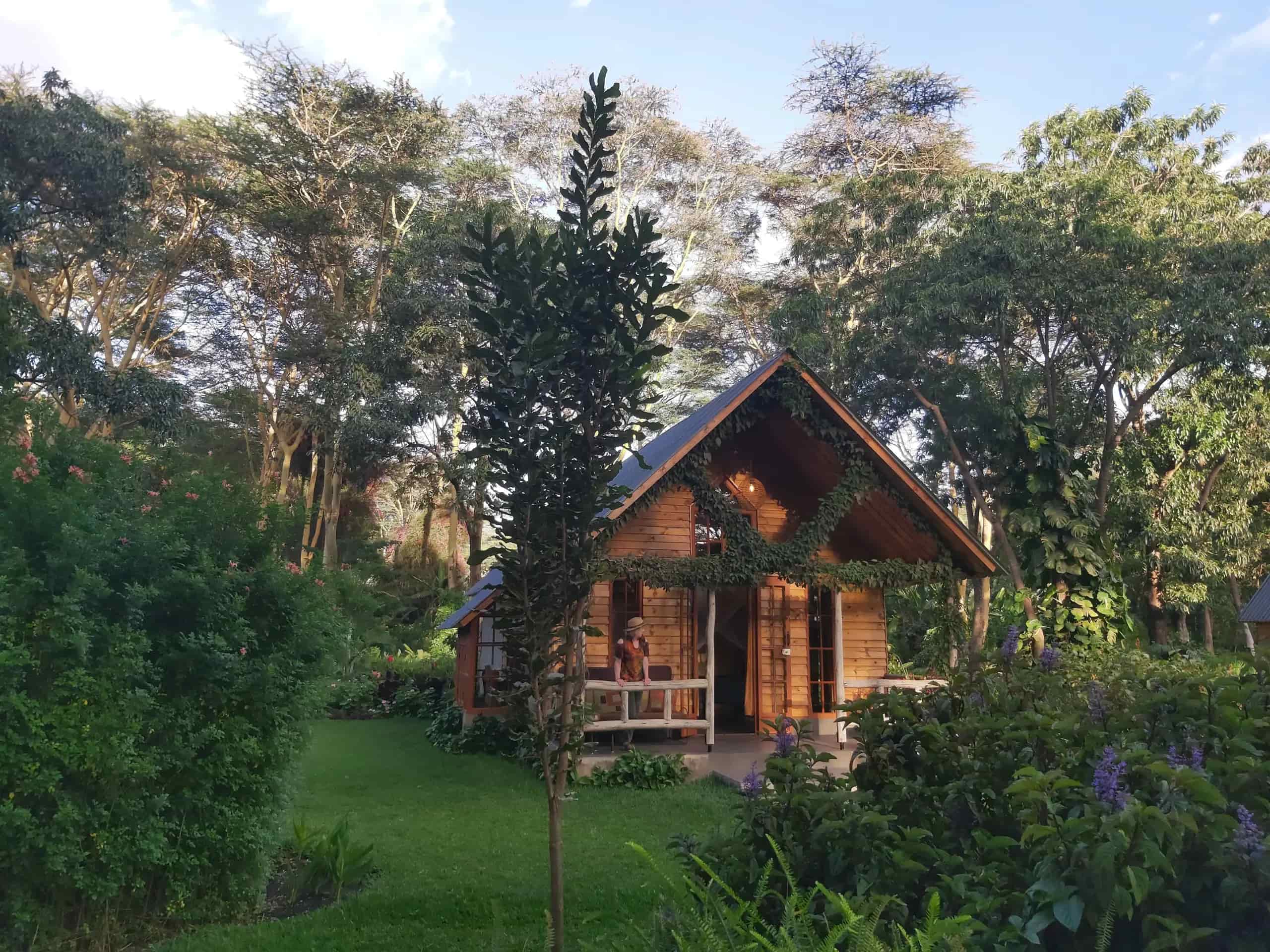 Cottage and tropical gardens at Tumbili Lodge in Arusha