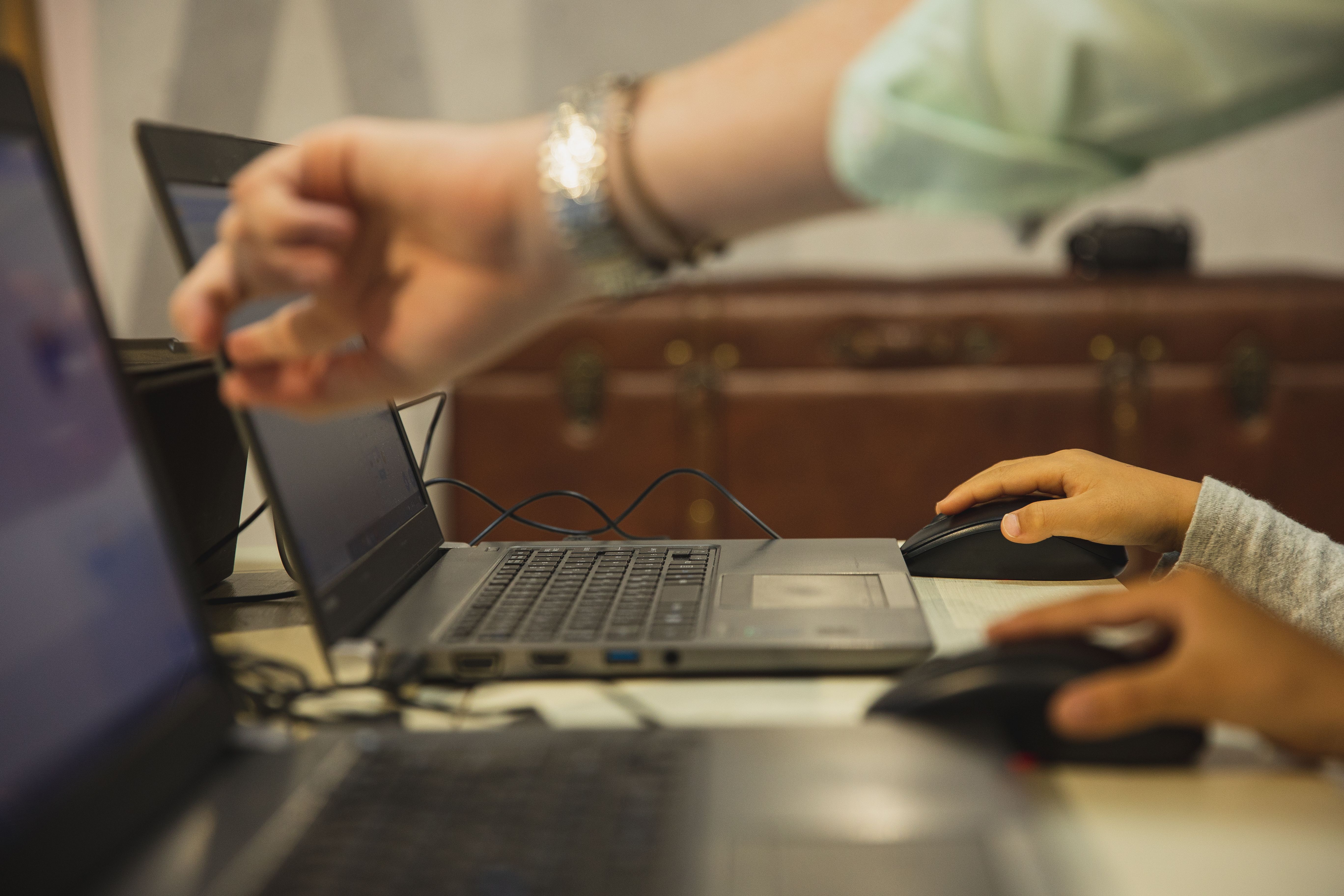 crop-anonymous-female-teacher-pointing-at-netbook-screen-near-schoolchildren-tou - ryutaro-tsukata (pexels)