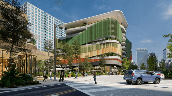 Street-level view of Water Street Tampa Phase 2 showing retail storefront with modern architectural design and outdoor plaza area