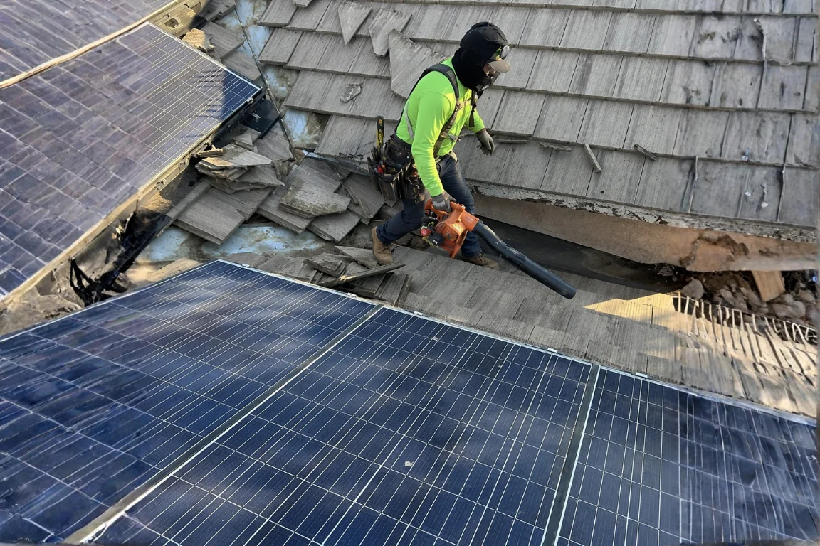 Tile roof leak repair crew inspecting broken tiles and worn roofing areas in Fresno