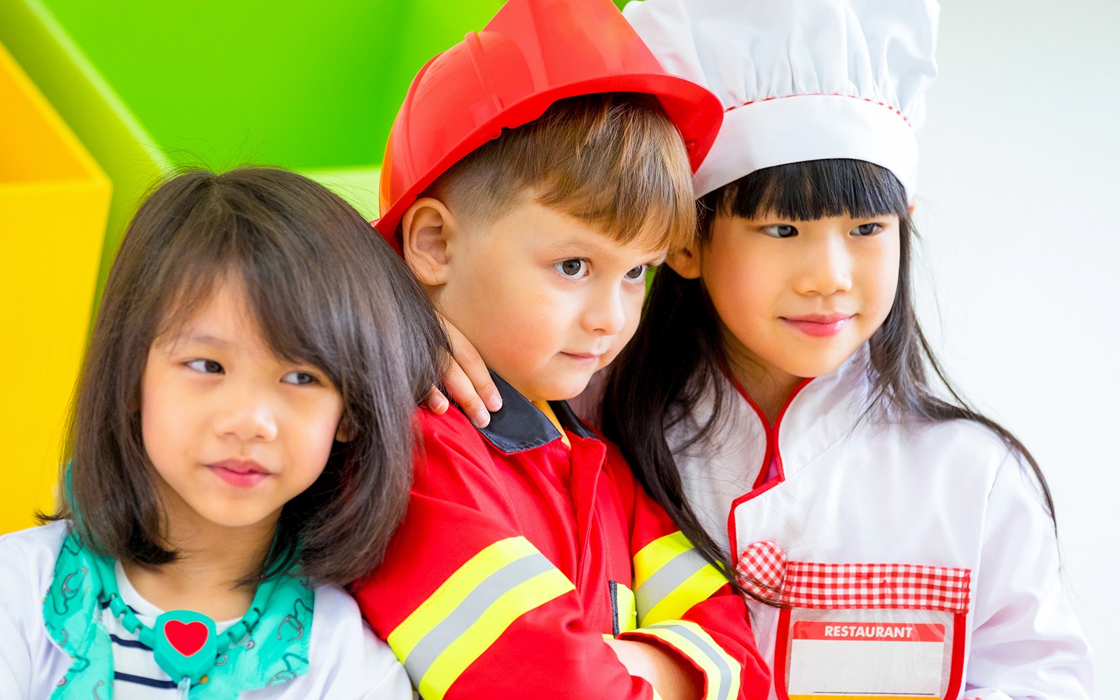 Children in costumes at KidsSTOP Singapore interactive exhibit.