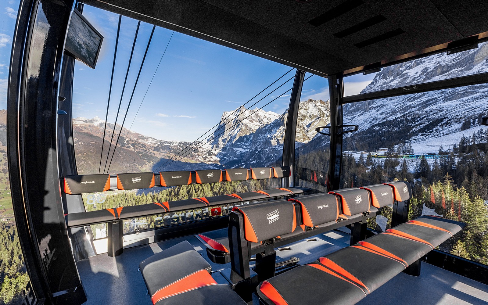 Jungfraujoch cable car interior with panoramic view of snow-capped Alps, Switzerland.