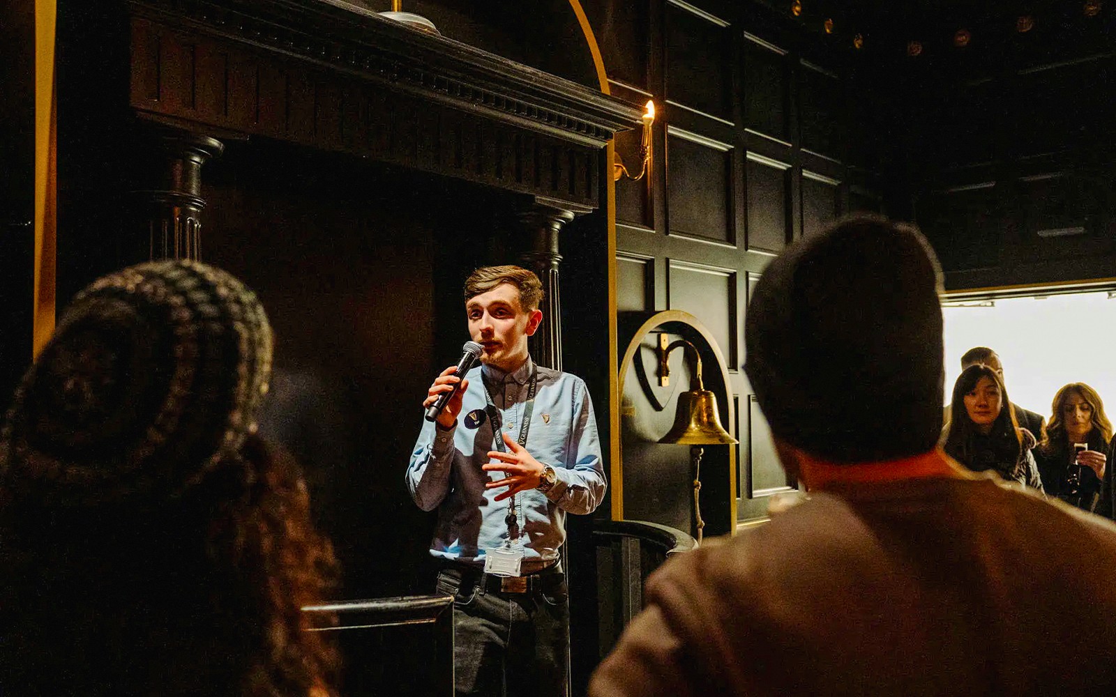 Tour guide speaking to visitors at Jameson Distillery, Dublin.