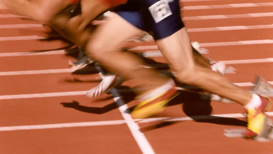 A woman running on a running track at night