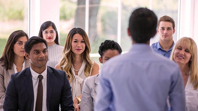 an audience listening to a speaker.