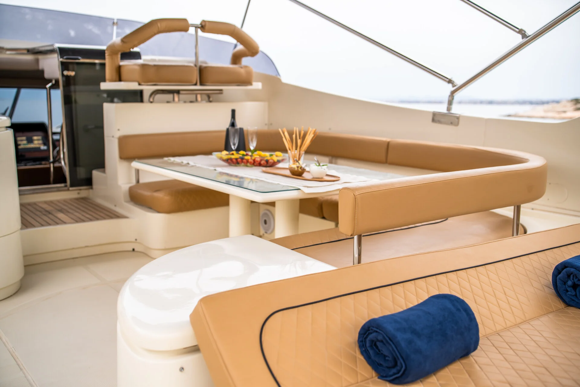 White Rock 36 speedboat with captain at helm cruising calm blue waters near Paros coastline with hills in background.