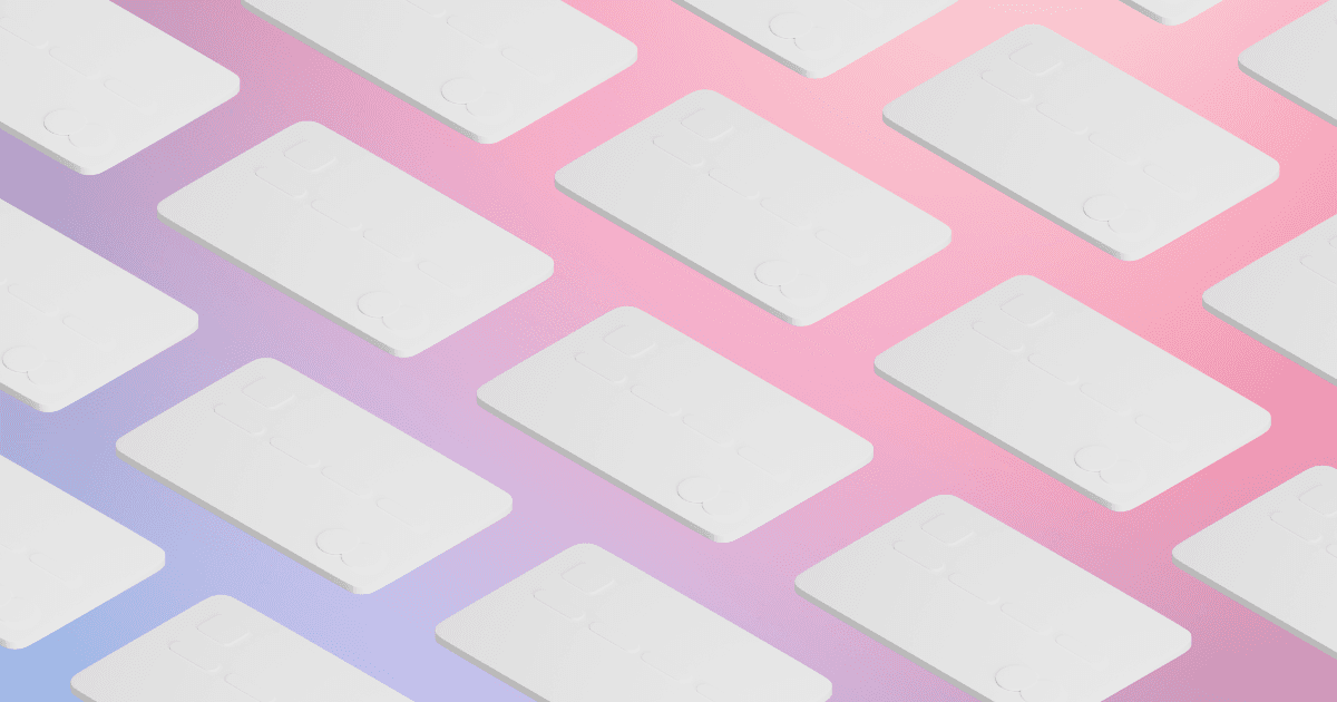 White credit cards against an ombre pink and purple background