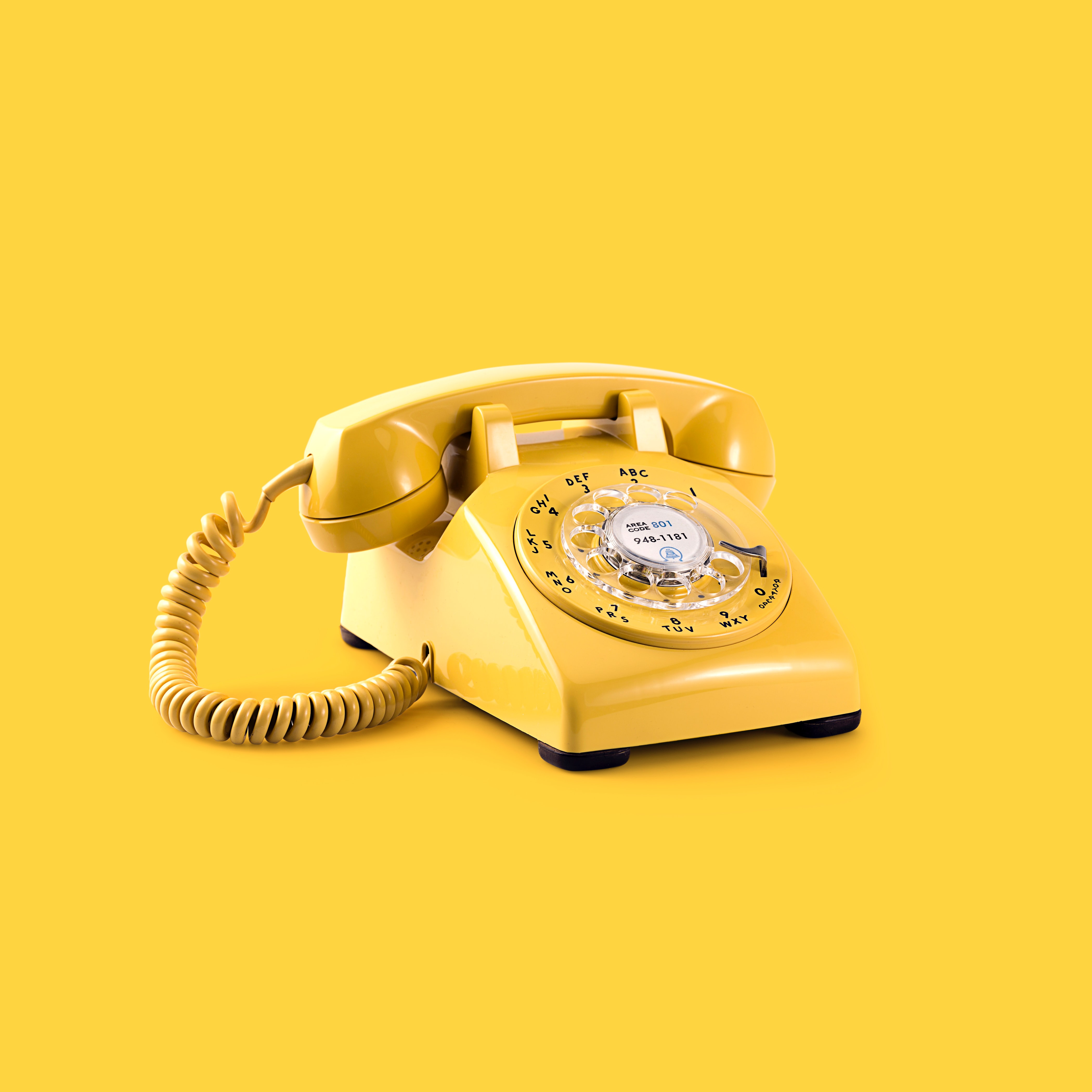 Image of a telephone on a yellow background