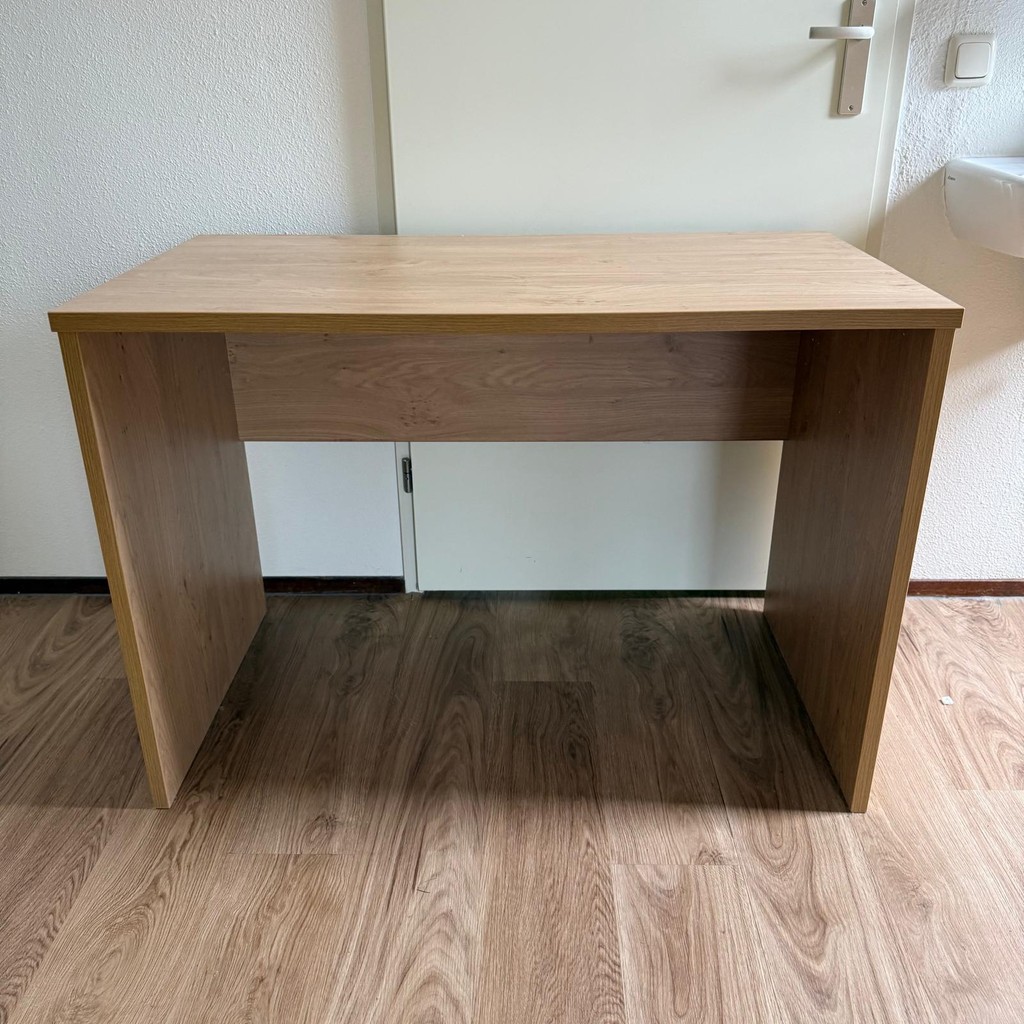 a group of people sitting at a table with a fire in the background