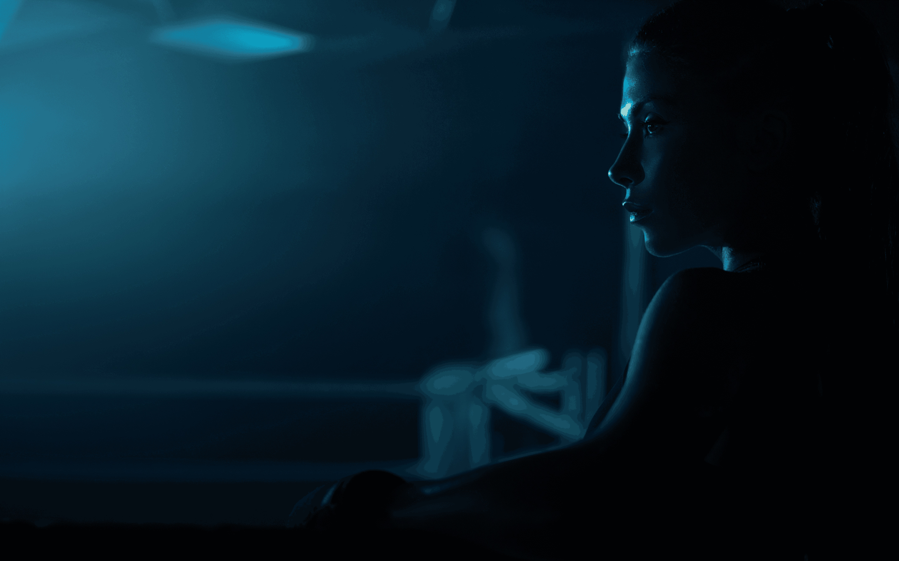 Cinematic profile of a woman in a dark boxing ring, illuminated by moody blue light.