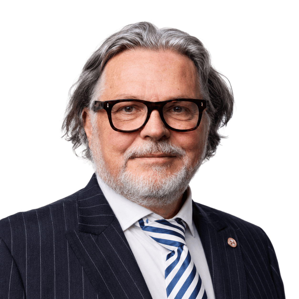 A studio headshot of a man wearing a suit and glasses