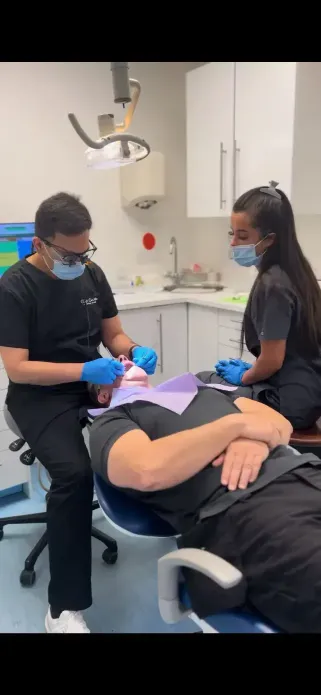 Dr Khalid and his nurse doing some dental work on a patient,