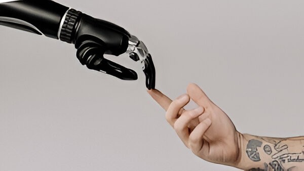 Robot hand touching a human finger