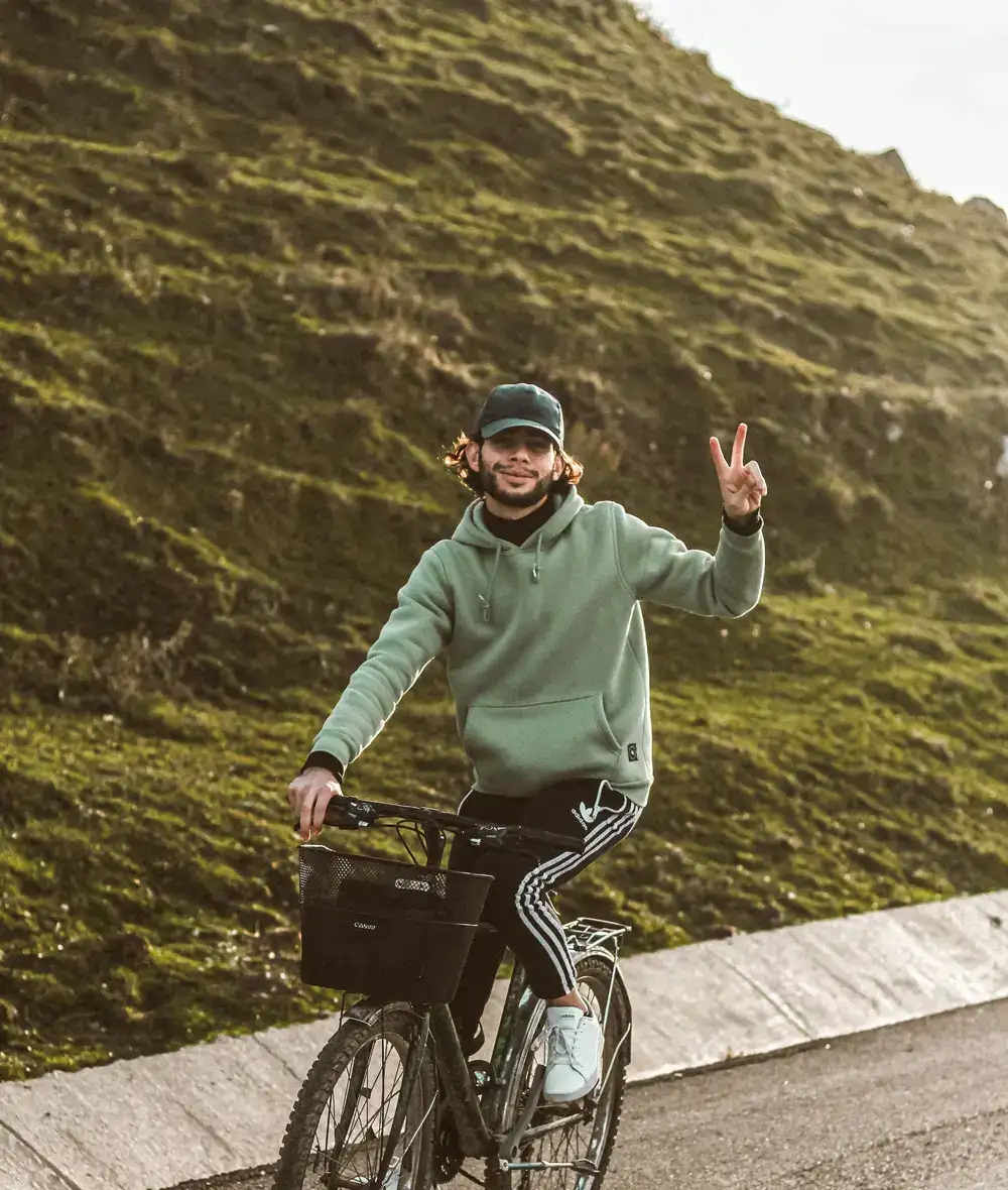 Riding a bicycle with V sign