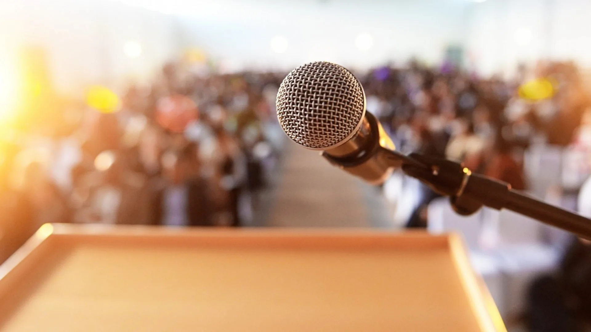 High school students in RISE summer programs practicing public speaking and communication; microphone on podium set for student presentation before large audience.