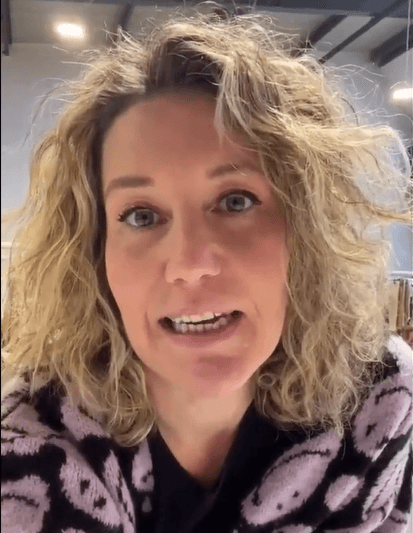 Close-up of lush, dark green leaves, some glossy and wet, against a muted background.