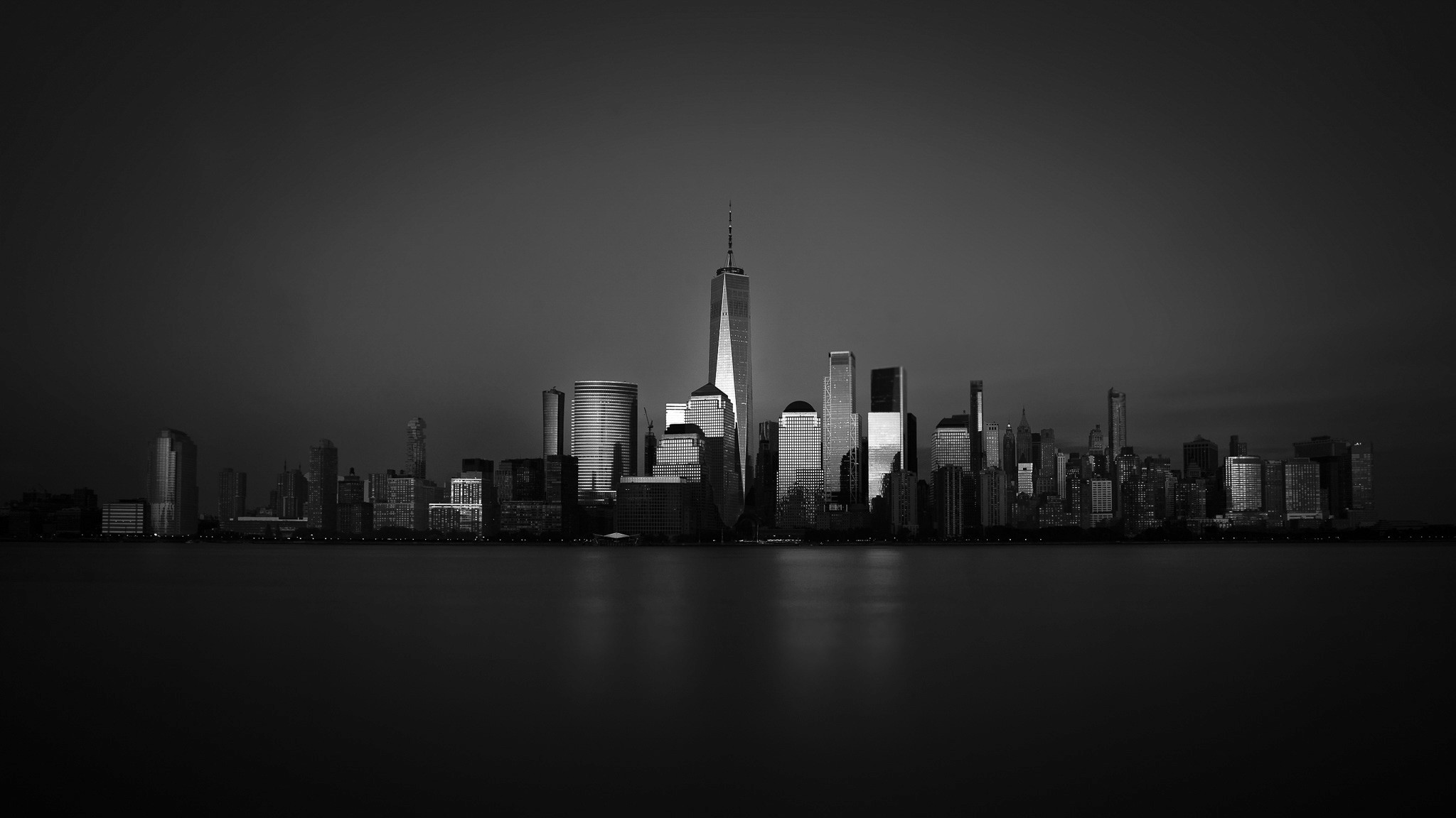 A ski slope glowing orange with rocky and snowy mountains in the background