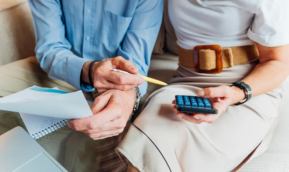 Couple reviewing retirement income plans with a financial adviser