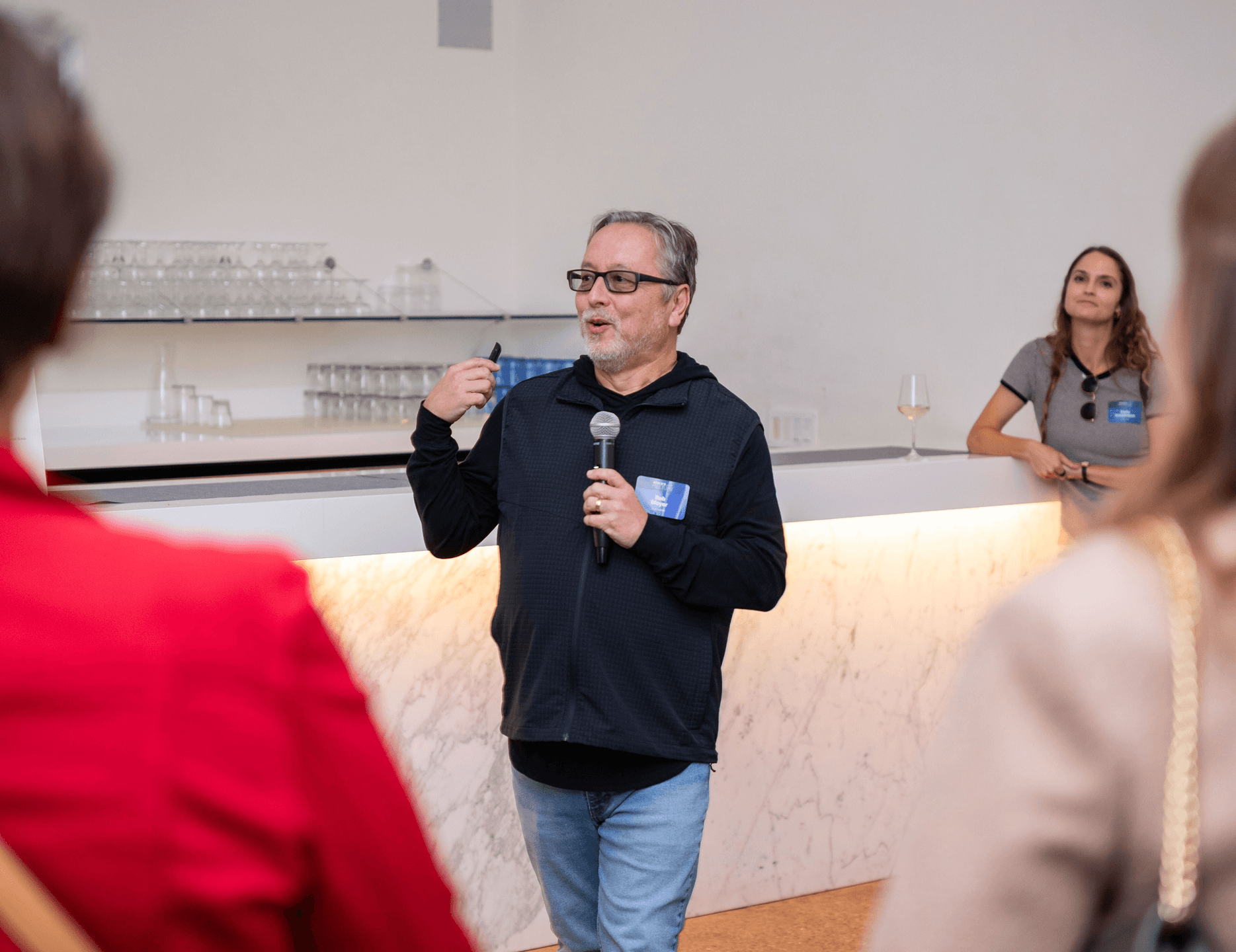 Rob Moyer presenting with microphone in modern conference space