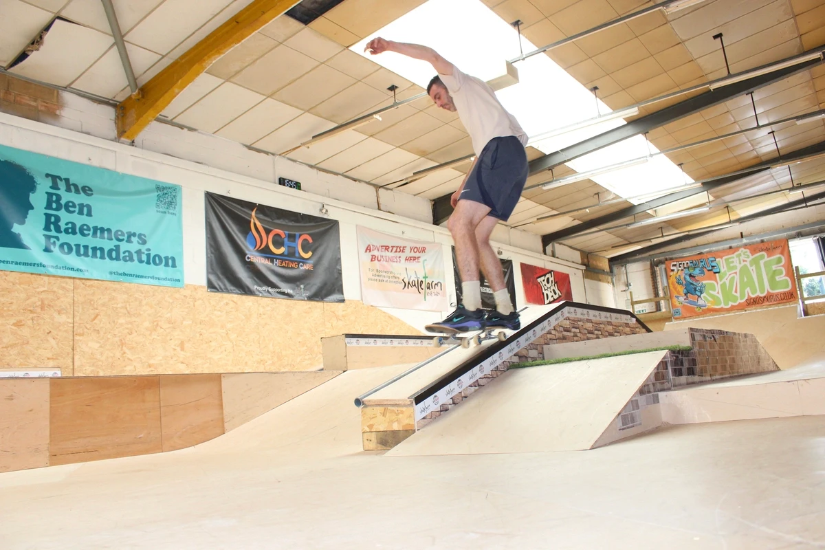 Tom coaching an adult beginner on the ramps at The Skate Farm indoor skatepark in Haywards Heath