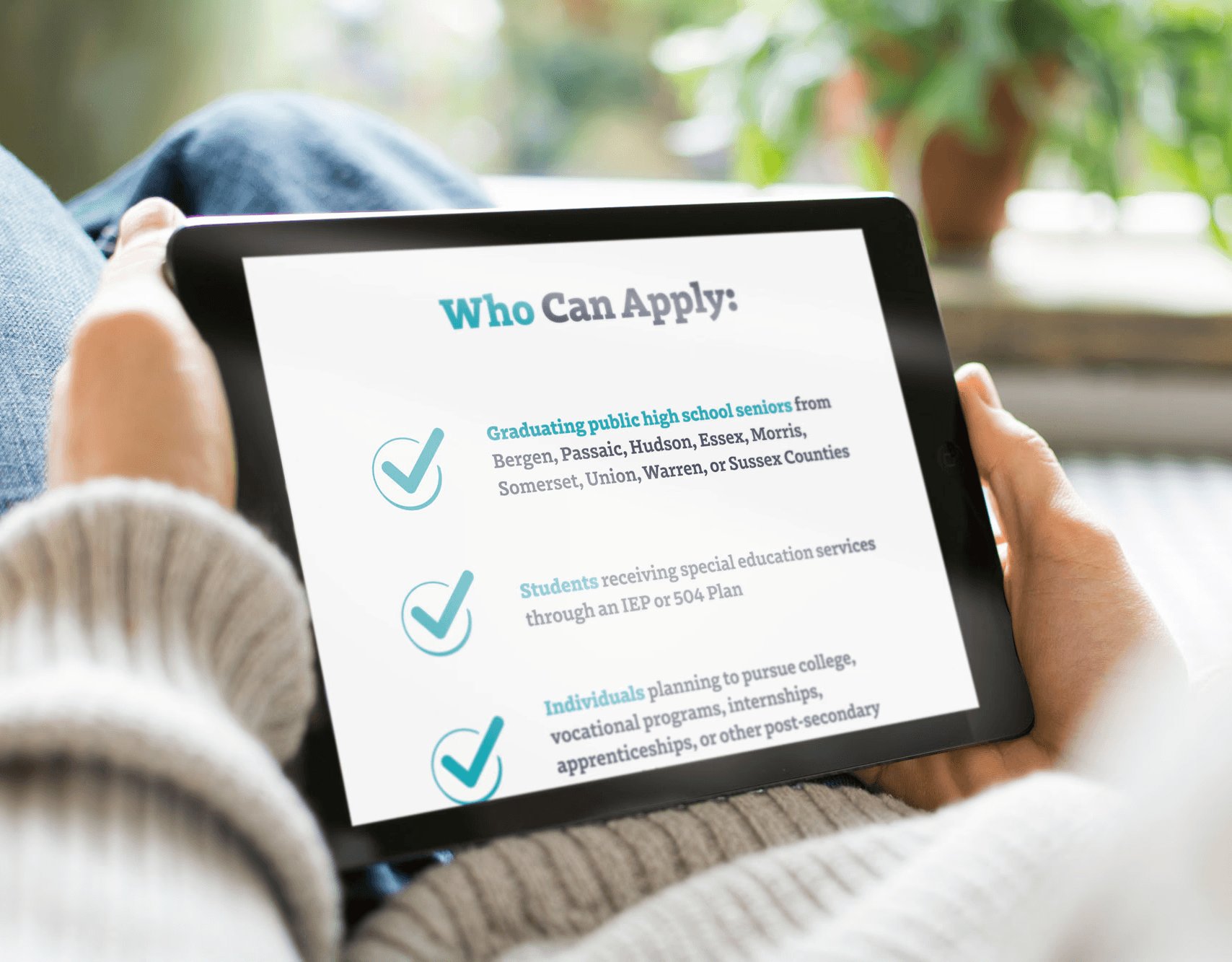 Person holding tablet scrolling through the email design of who can apply