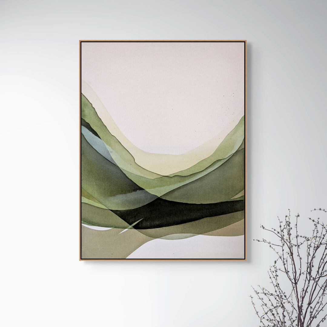 Framed abstract artwork featuring soft green and pastel waves on a light background, hanging on a wall.