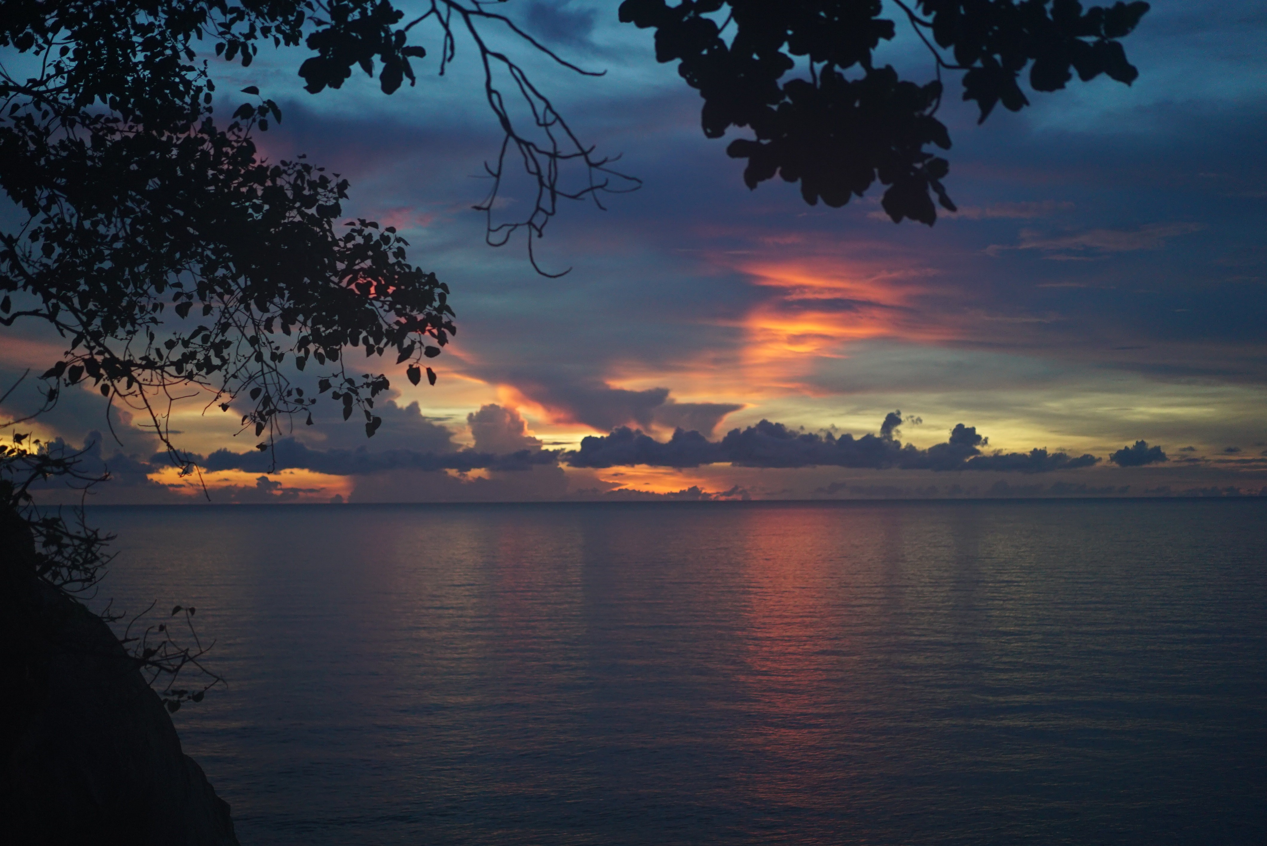 white boats on ocean water under gray sky