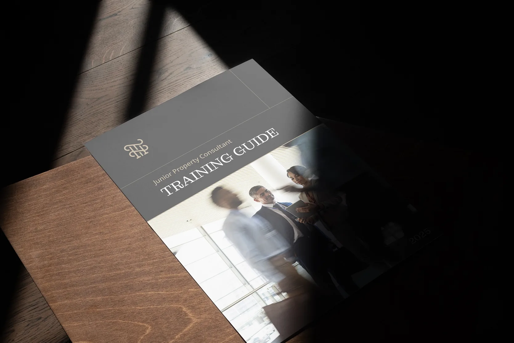 Thrive training guide for junior property consultants on a wooden table